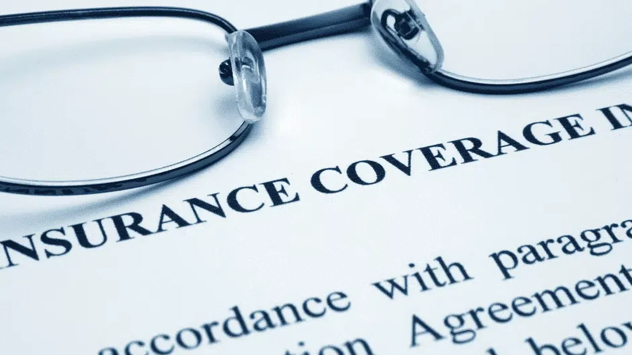 blue bowl of black bean beef tortilla soup on a board with cilantro and shredded cheese in background